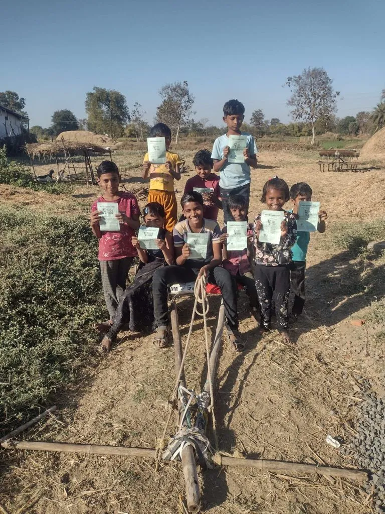 Group of children holding papers outdoors